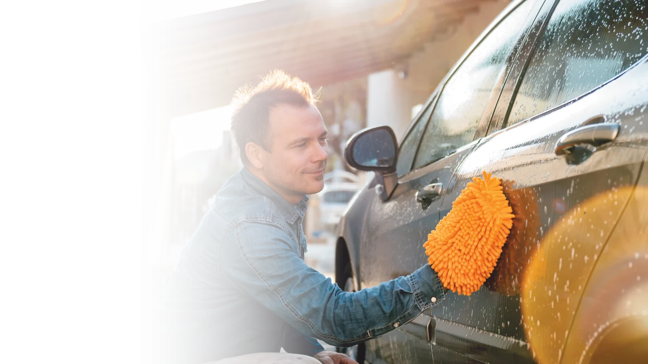 Man washing car with wash rag