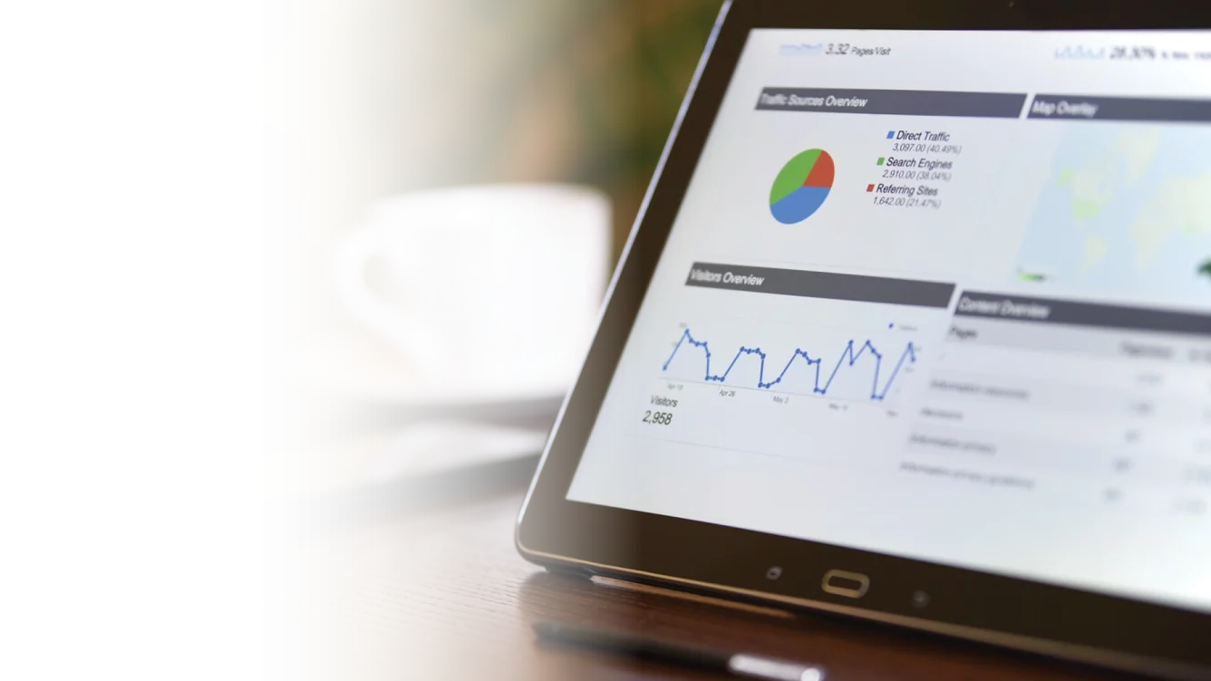 Closeup of a tablet device with a dashboard of data charts and graphs